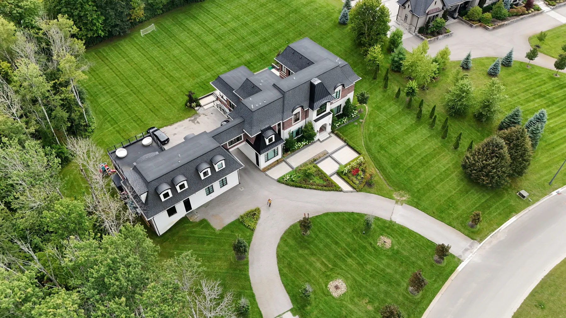 Aerial view of a Northroot property with neatly striped lawns and mature trees